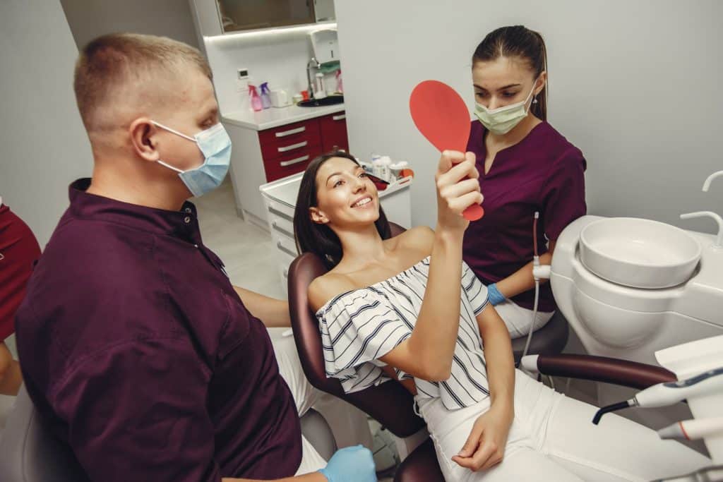 Young female patient smiling at the dentist